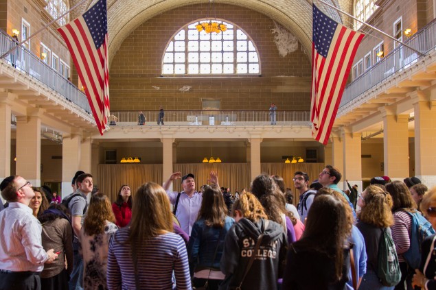 Experienced tour guide and Yeshiva University Alumnus Yitzchak Schwartz walks students through the footsteps of their grandparents in the inspection halls of Ellis Island as part of YU's Family Discovery Club's first event. The Family Discovery Club is a club for students at YU interested in researching their personal family histories. Photo: David Kabinsky/Yeshiva University