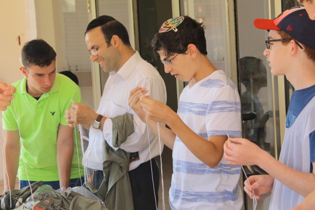 NCSY Kollel students made army-authorized camouflage green tzitzit, which were then distributed to those on the front lines immediately upon their completion.