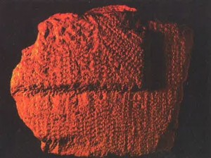 (Plates #6a, 6b) Two types of building stones.  The stone with the weave-like pattern was used in building outside the azarah courtyard.  The fragment of splintered stone with the smooth center was used within.