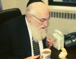 Rabbi Belsky in his office at OU national headquarters in Manhattan, evaluating the kashrut of chicks vaccinated in the egg.