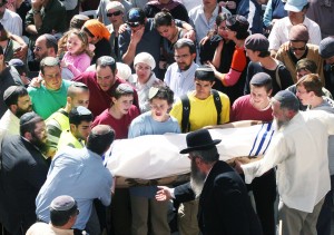 Mourners carry the body of one of the students killed in the terror shooting attack at the Mercaz HaRav Yeshiva in Jerusalem. Photo: Ariel Jerozolimski 