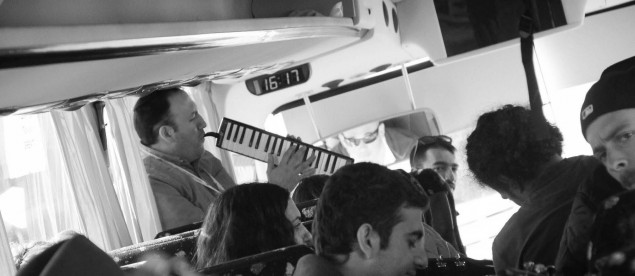 Jamming on the bus during the musical Birthright trip. Tour leader Yitzy Glicksman is playing a melodica, a combination between a keyboard and a harmonica. 